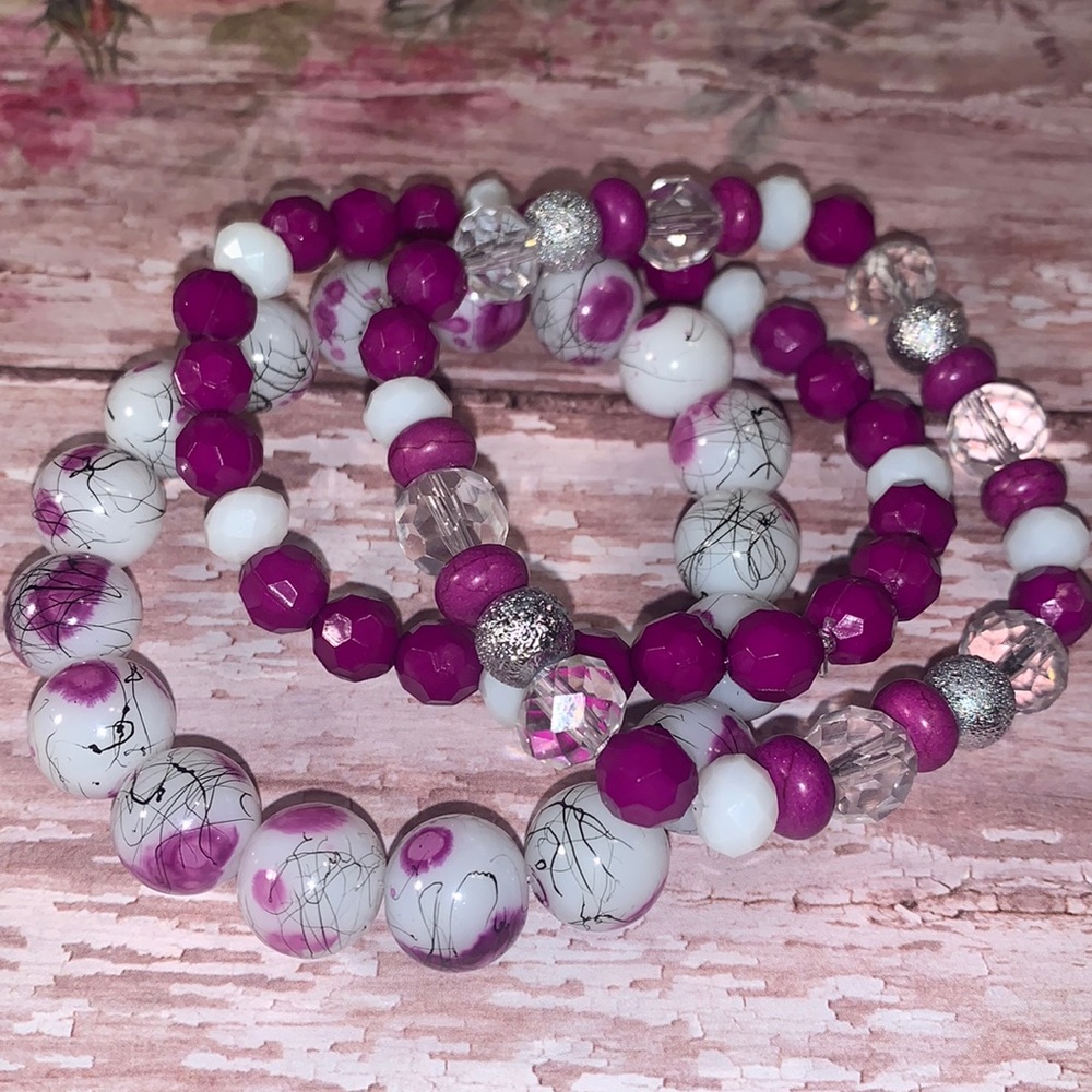 Purple and white  stack of stretch bracelets